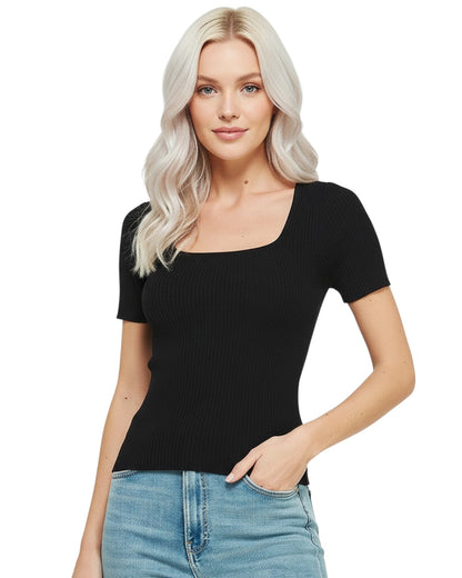 Woman wearing a black ribbed top and blue jeans on a white background.