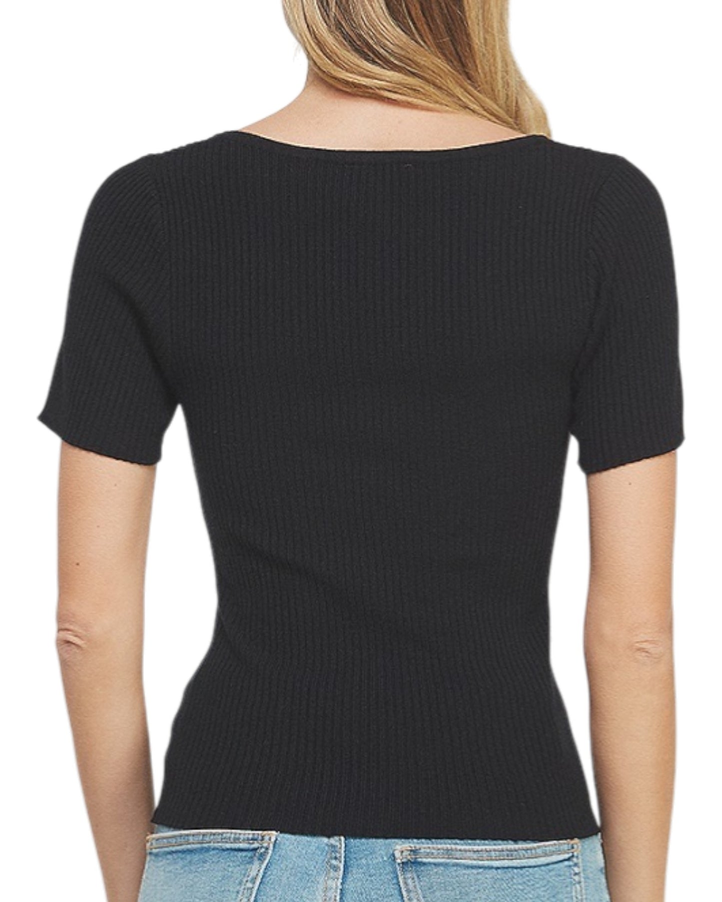 Black ribbed knit top worn by a person on a white background.