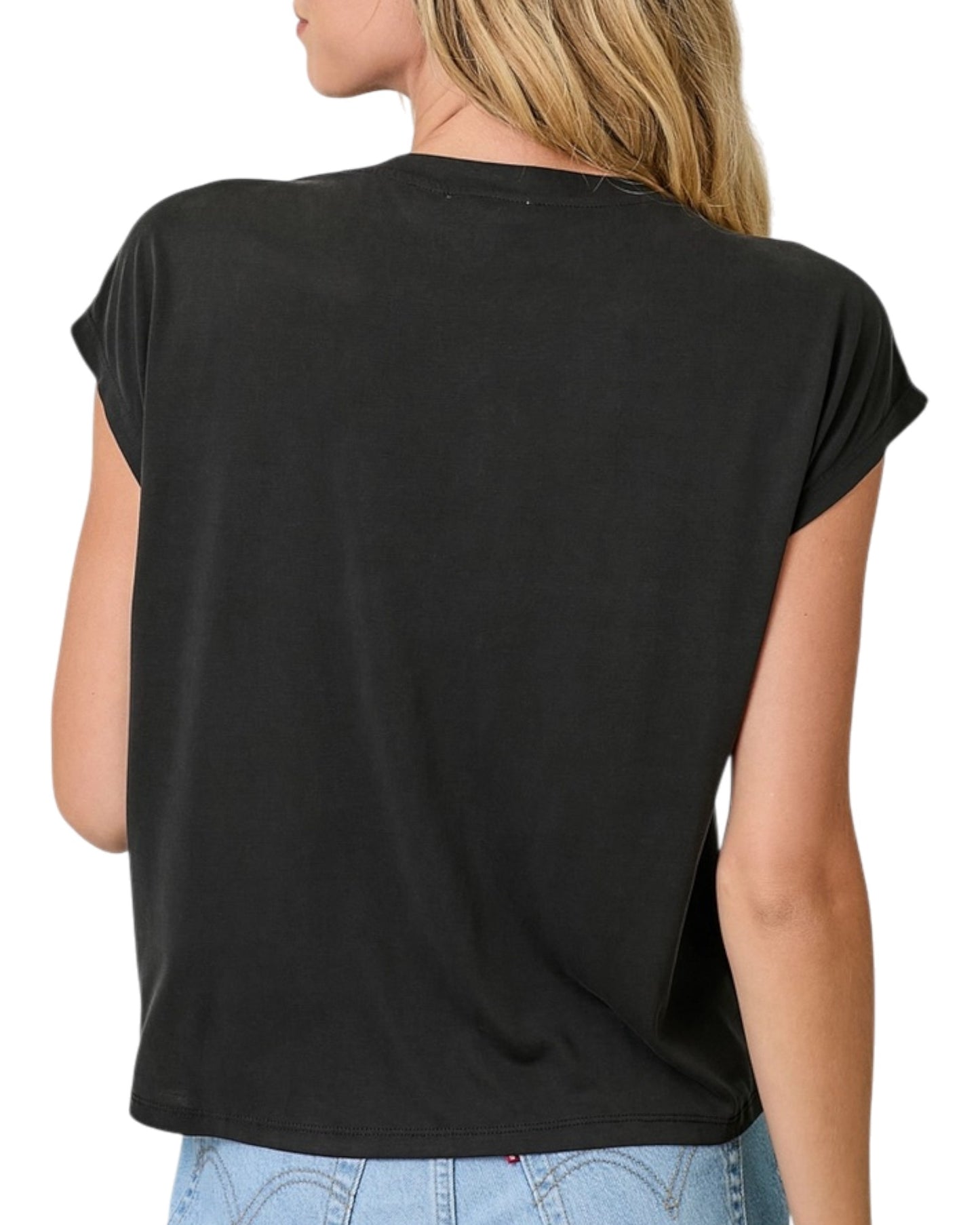Black cap sleeve top worn by a person on a white background.