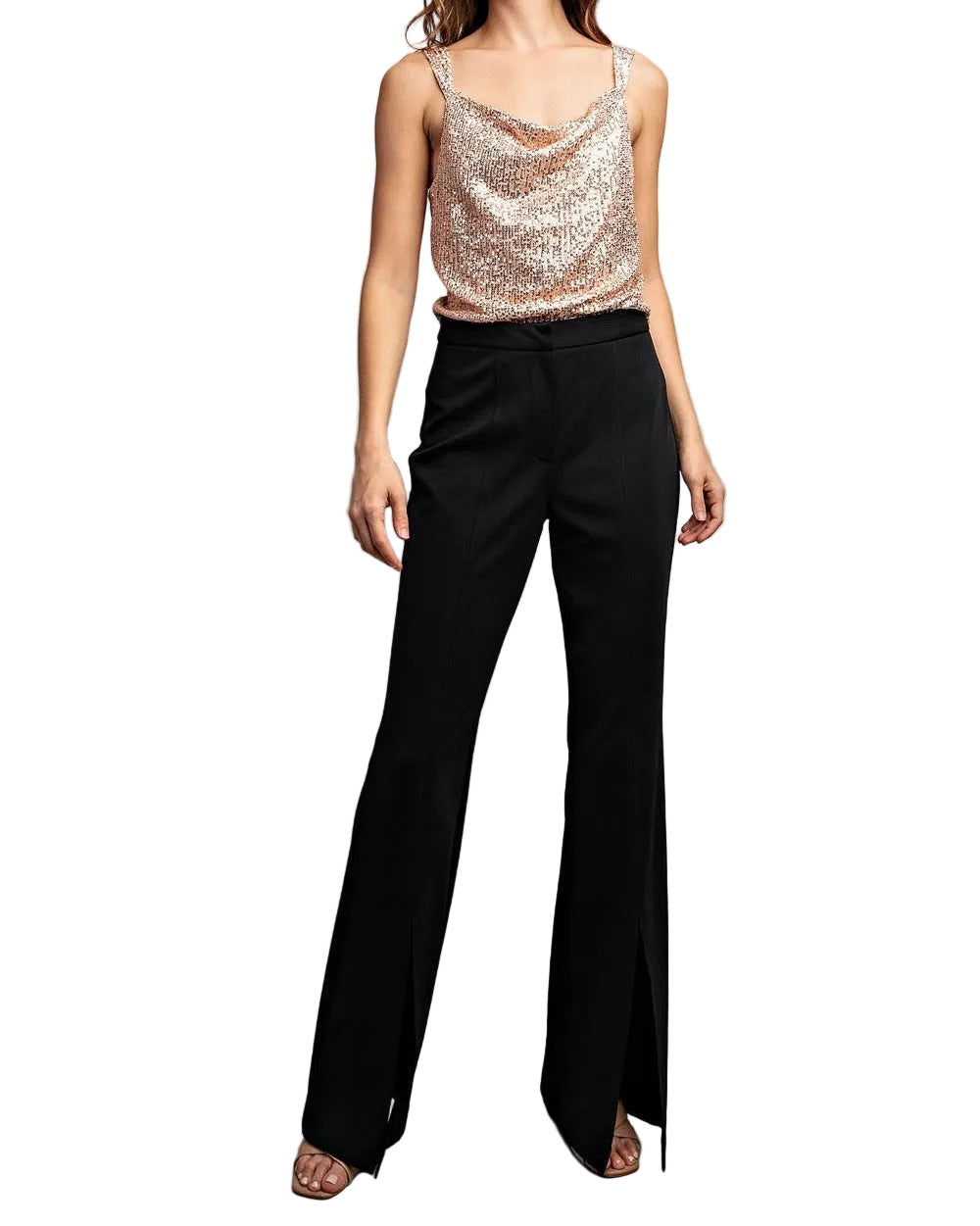 Woman wearing a sequin top and black pants against a plain background