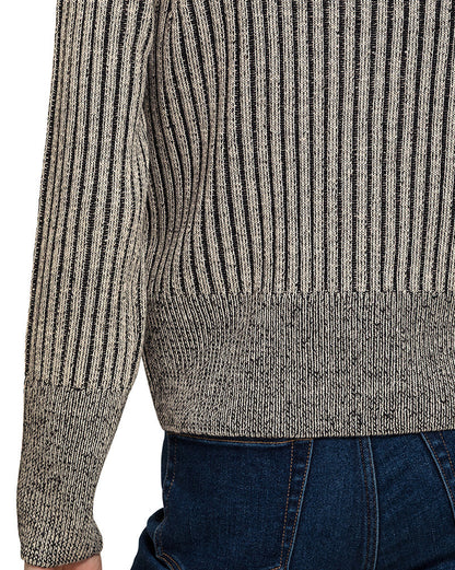 Woman wearing a charcoal ribbed knit zip up cardigan over a white top and blue jeans on a white background. 