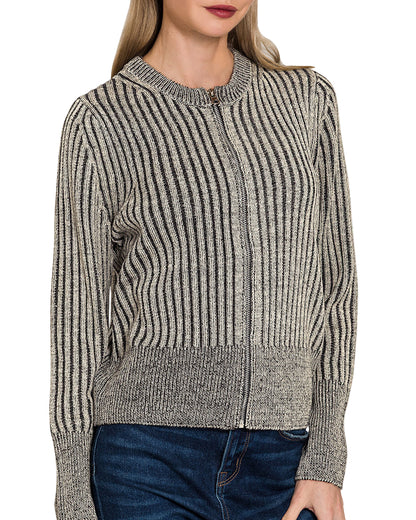 Woman wearing a charcoal heathered ribbed zip up sweater cardigan with a white background.