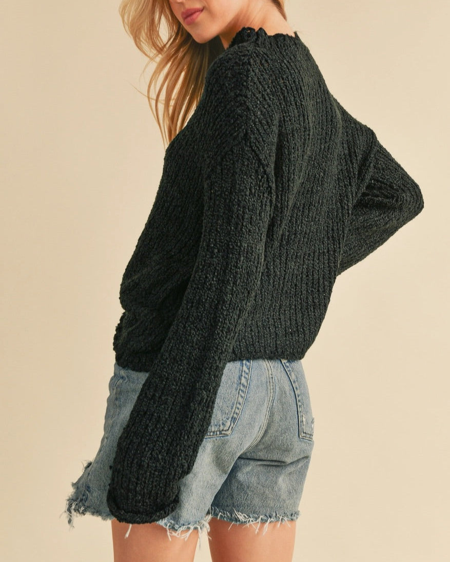 Black textured mock neck sweater with boxy relaxed fit.