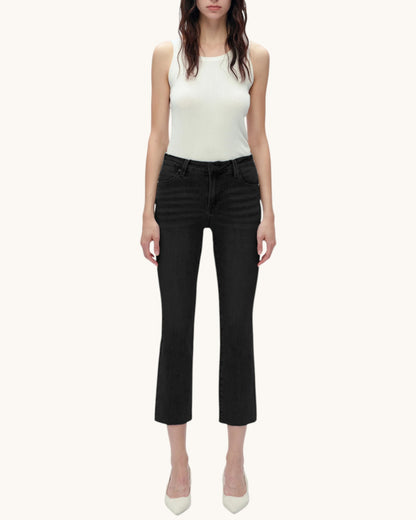 Person wearing black jeans and a white tank top on a white background.