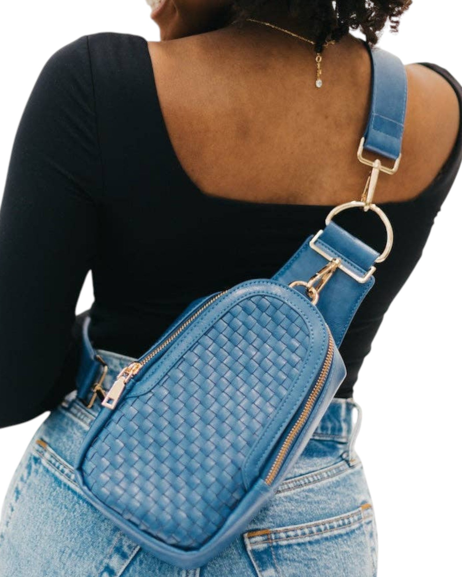 Blue woven crossbody bag worn by a person on a white background.