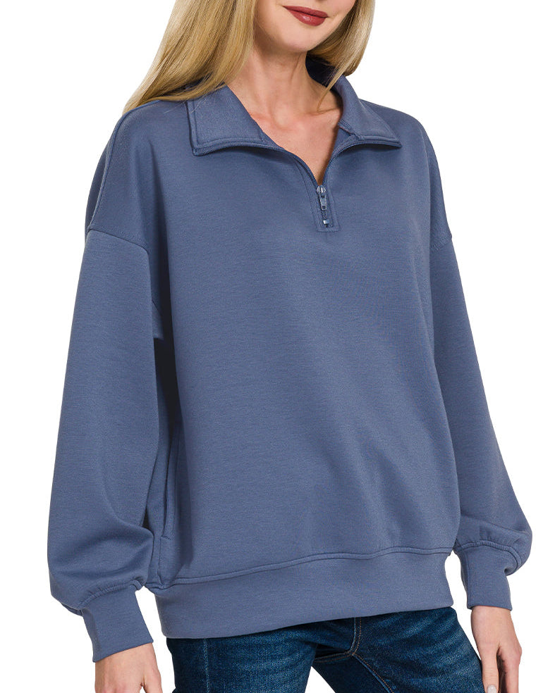 Woman wearing a Blue Indigo half-zip scuba pullover with relaxed fit and soft stretch fabric.