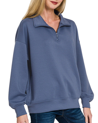 Woman wearing a Blue Indigo half-zip scuba pullover with relaxed fit and soft stretch fabric.