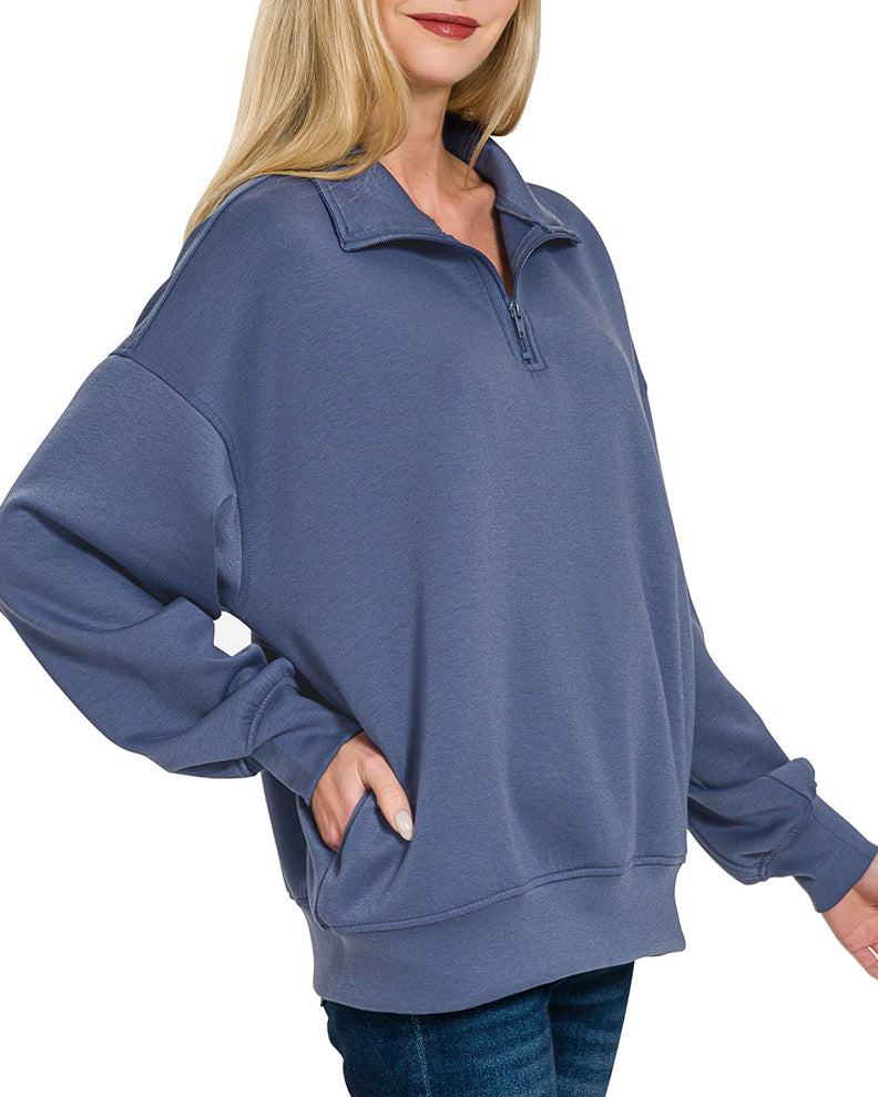 Woman wearing a Blue Indigo half-zip scuba pullover with relaxed fit and soft stretch fabric.