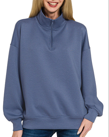 Woman wearing a Blue Indigo half-zip scuba pullover with relaxed fit and soft stretch fabric.