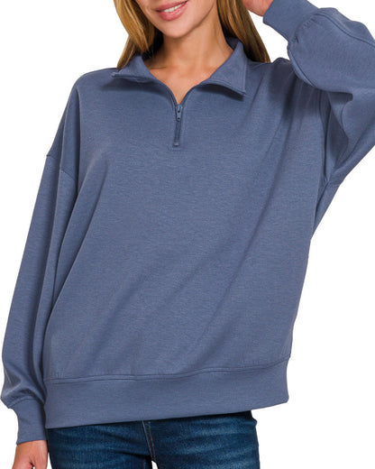 Woman wearing a Blue Indigo half-zip scuba pullover with relaxed fit and soft stretch fabric.