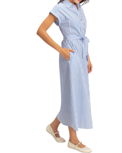 Woman wearing a blue and white striped dress on a white background.