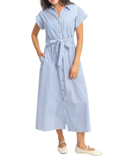 Woman wearing a blue and white striped shirt dress on a white background.