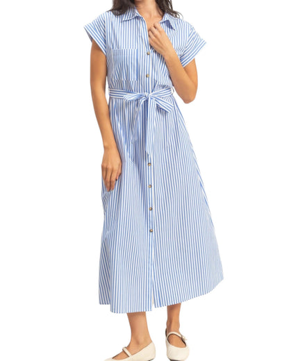 Woman wearing a blue and white striped dress on a white background.