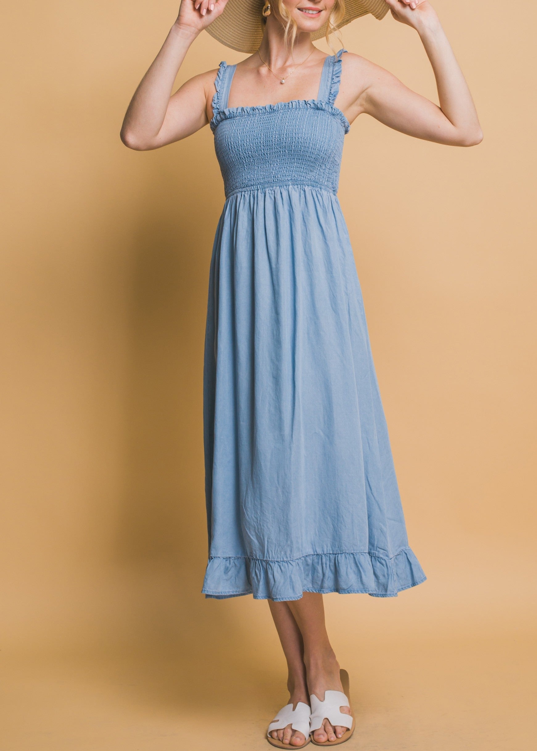 Light blue maxi dress with smocked waist, flounce hem, and ruffle straps in airy Tencel fabric.