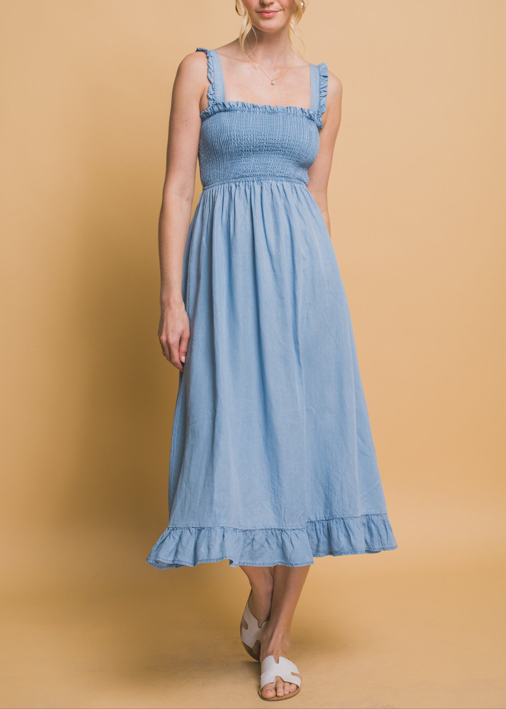 Light blue maxi dress with smocked waist, flounce hem, and ruffle straps in airy Tencel fabric.