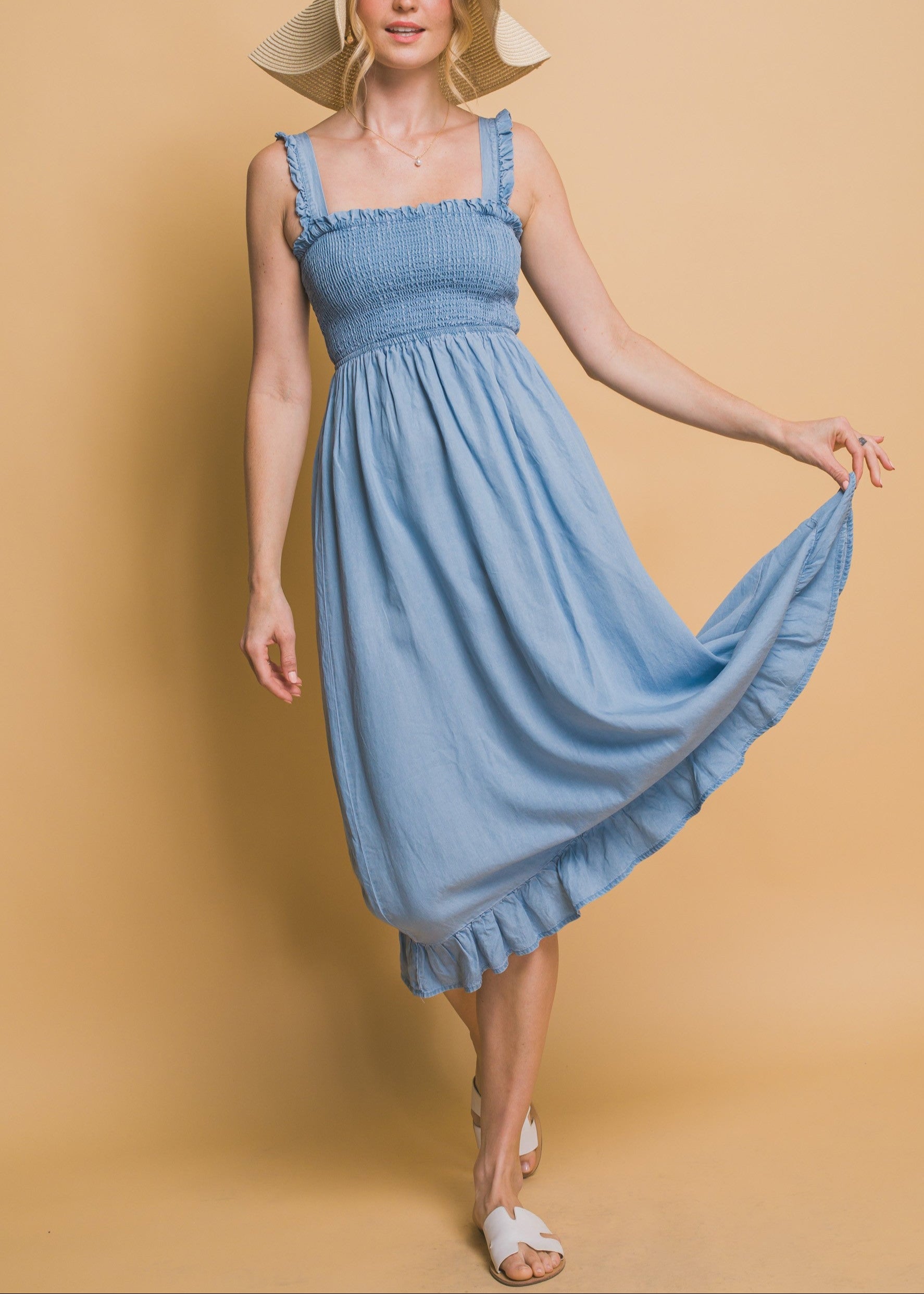 Light blue maxi dress with smocked waist, flounce hem, and ruffle straps in airy Tencel fabric.