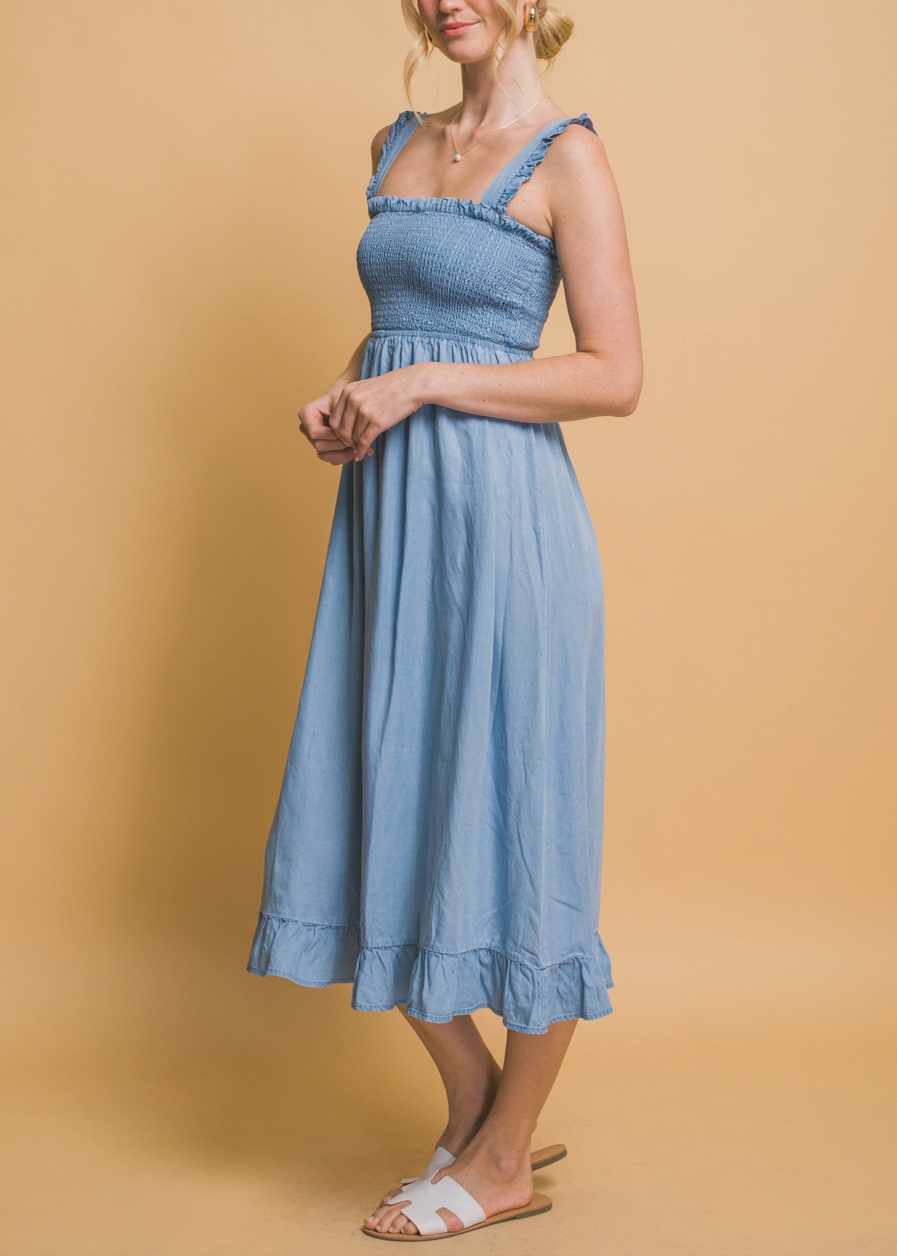 Light blue maxi dress with smocked waist, flounce hem, and ruffle straps in airy Tencel fabric.