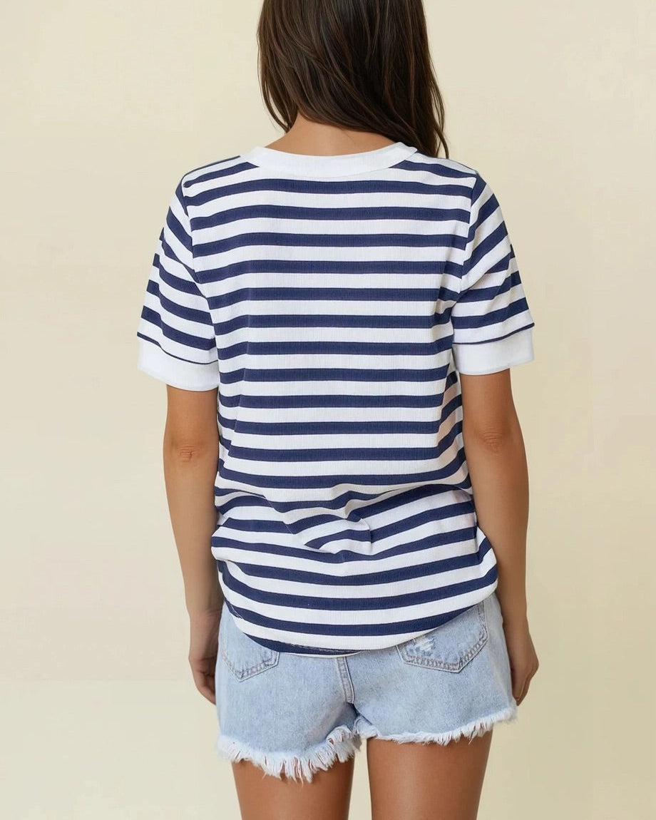 Navy and white striped knit V-neck short sleeve top with white trim.