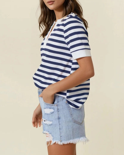 Navy and white striped knit V-neck short sleeve top with white trim. 