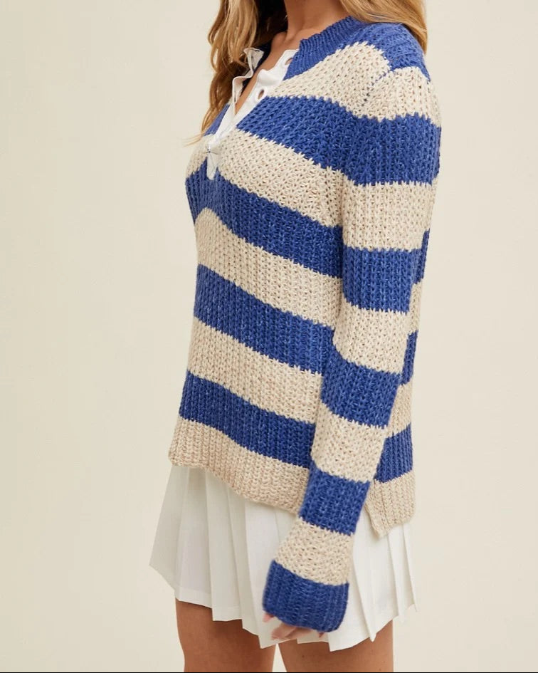 Woman wearing a blue and white striped sweater on a beige background.