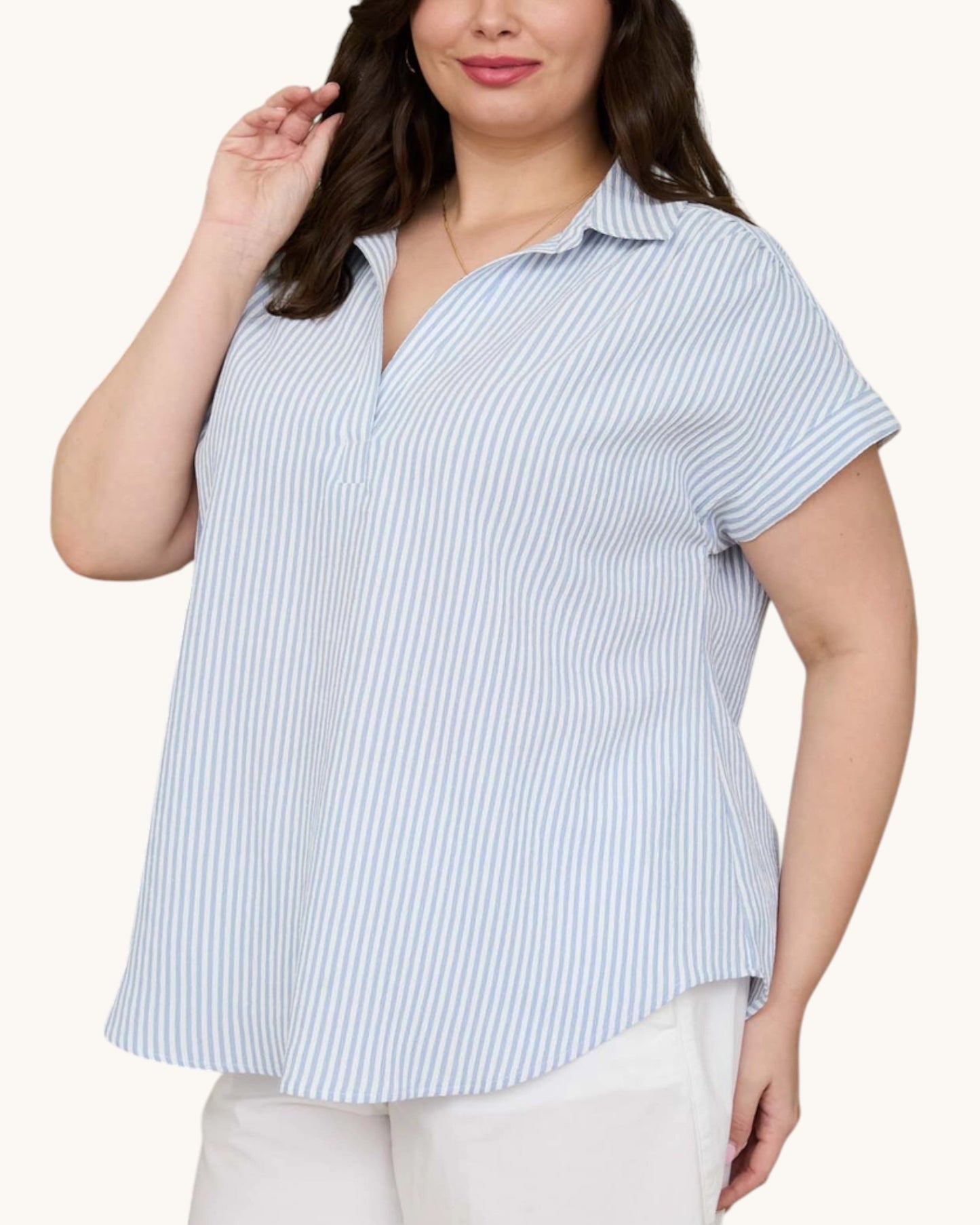 Woman wearing a blue and white striped shirt on a white background.