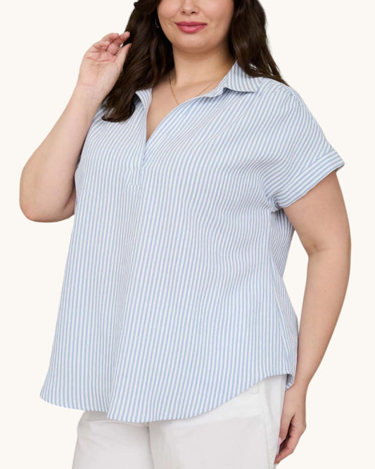 Woman wearing a blue and white striped shirt on a white background.