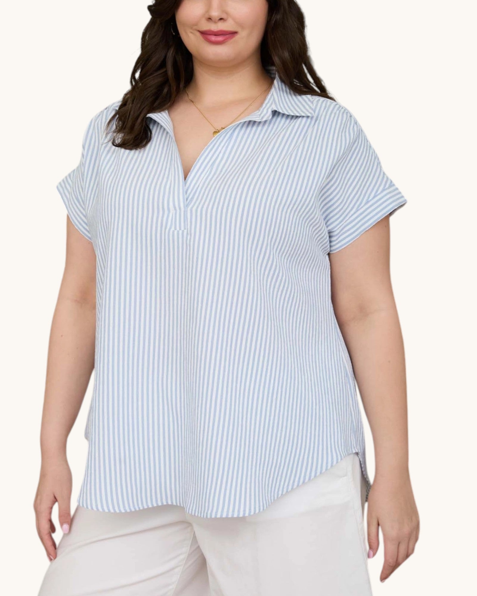 Woman wearing a blue and white striped shirt on a white background.