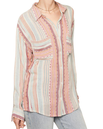 Multicolored striped shirt worn by a person on a white background