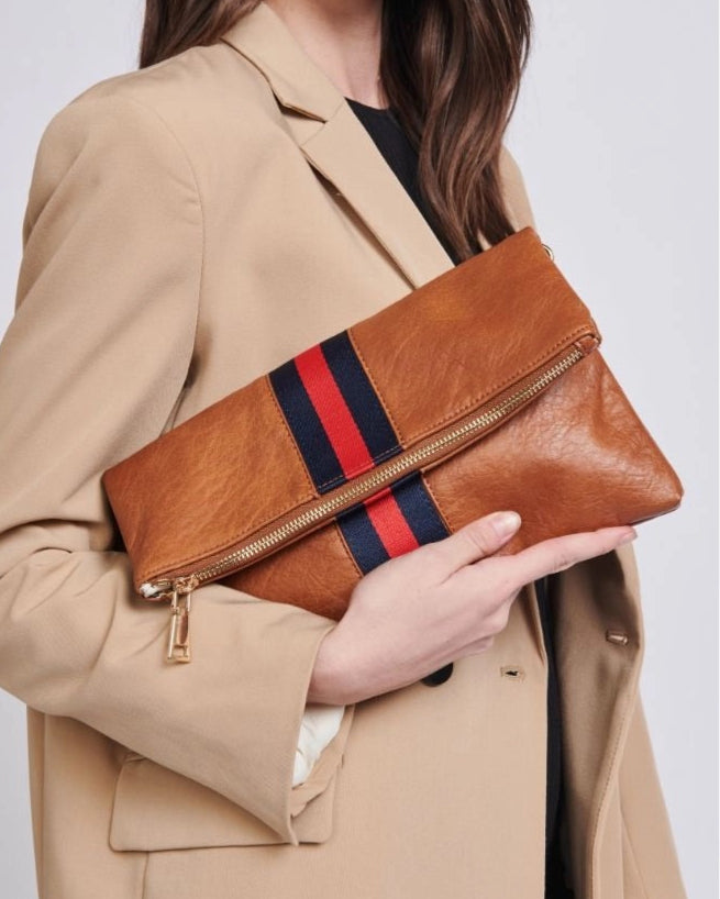 Brown vegan leather fold over clutch bag with sporty navy and red stripe, zipper and gold strap.