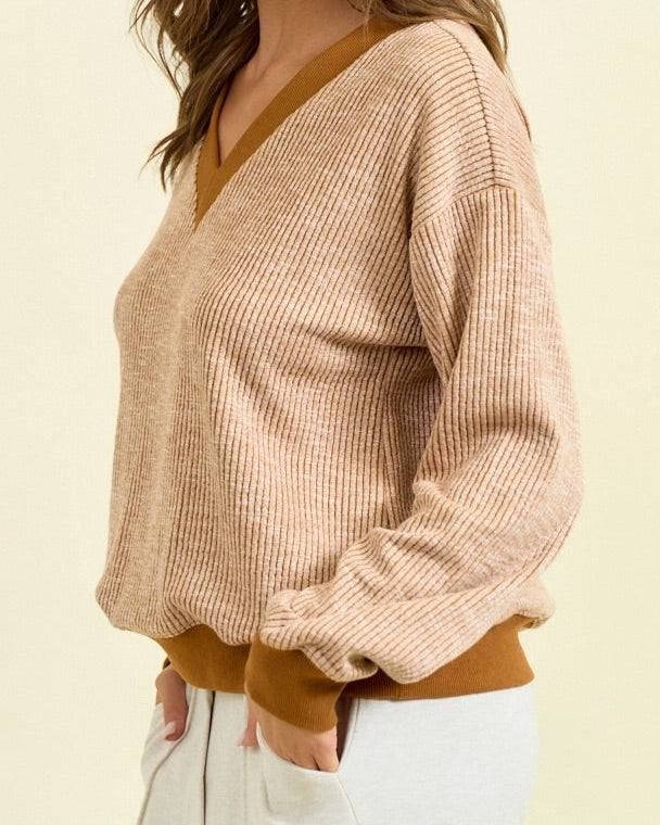 Camel ribbed V-neck pullover with contrast trim, vertical texture, and relaxed fit.
