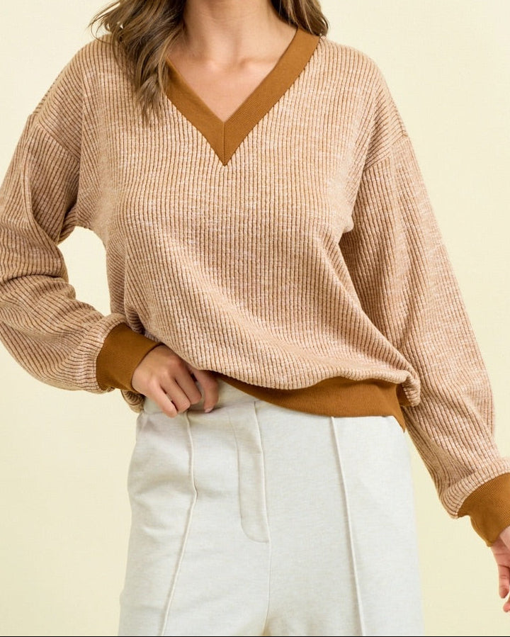 Camel ribbed V-neck pullover with contrast trim, vertical texture, and relaxed fit.
