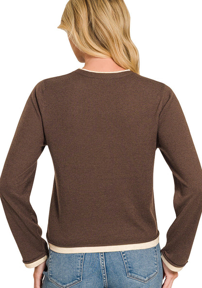 A woman shown from the back wearing a brown long-sleeve knit top with contrasting cream ribbed trim at the crew neck, cuffs, and hem, paired with blue jeans on a white background.