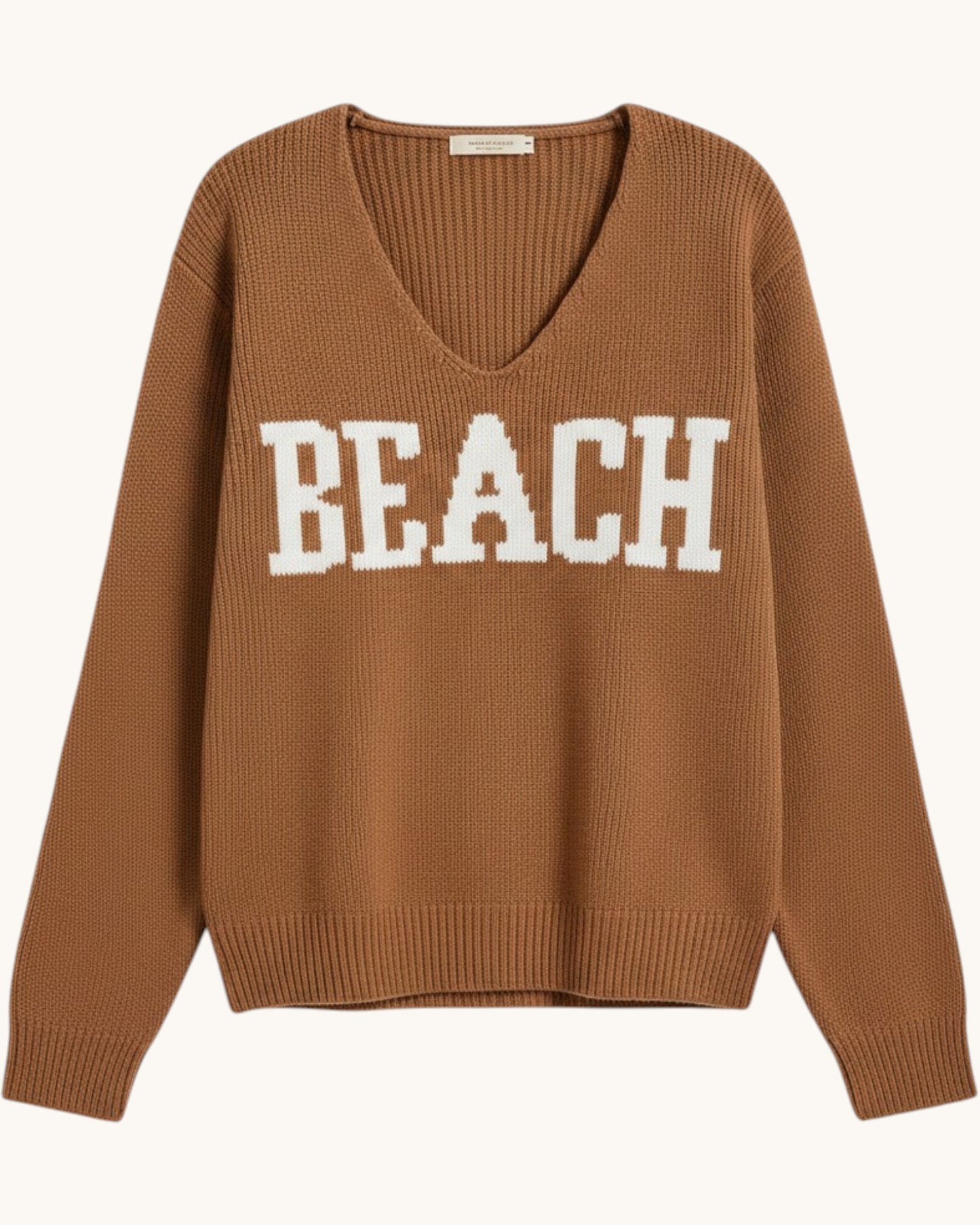 Brown/deep camel  v-neck sweater with 'BEACH' text on a white background.