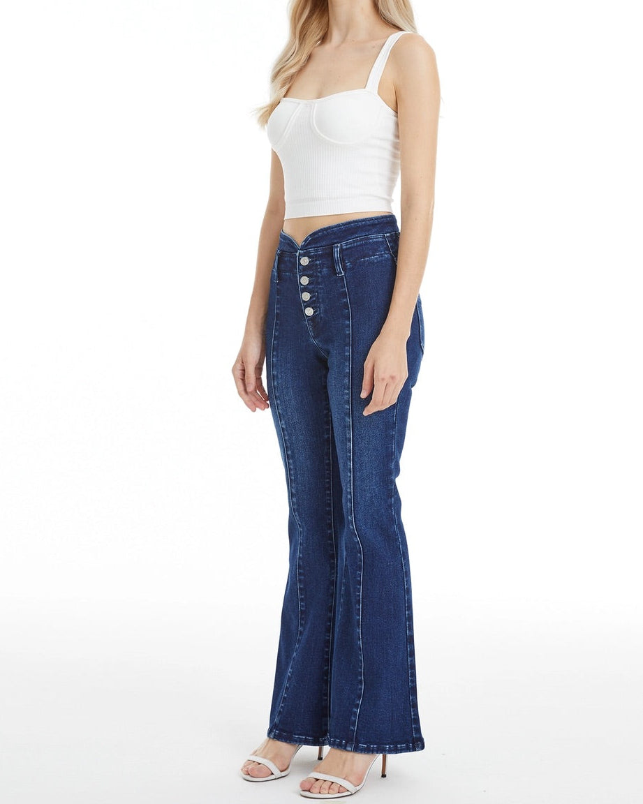 Dark blue flare jeans with V-shaped contoured waistband and button fly closure.