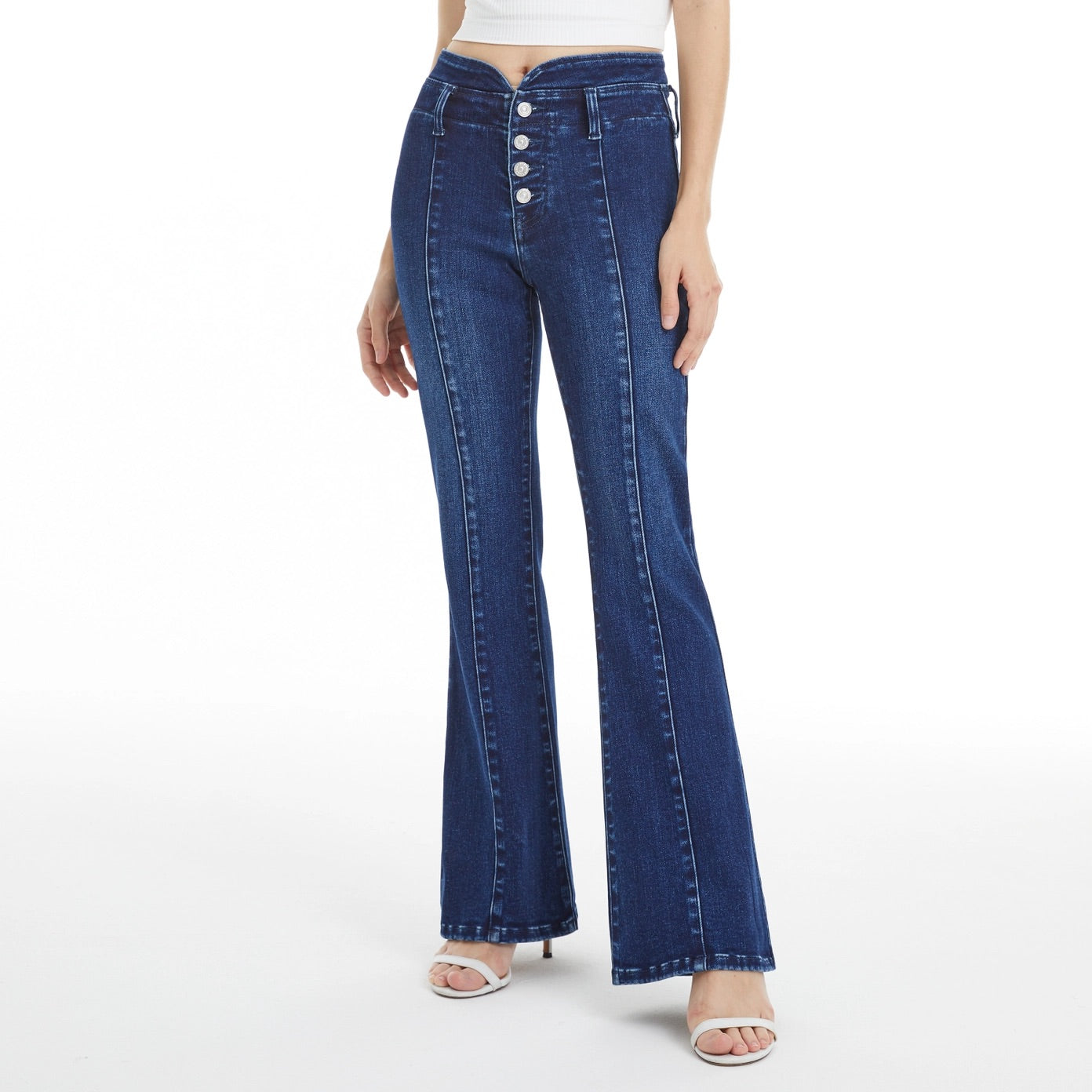 Dark blue flare jeans with V-shaped contoured waistband and button fly closure.