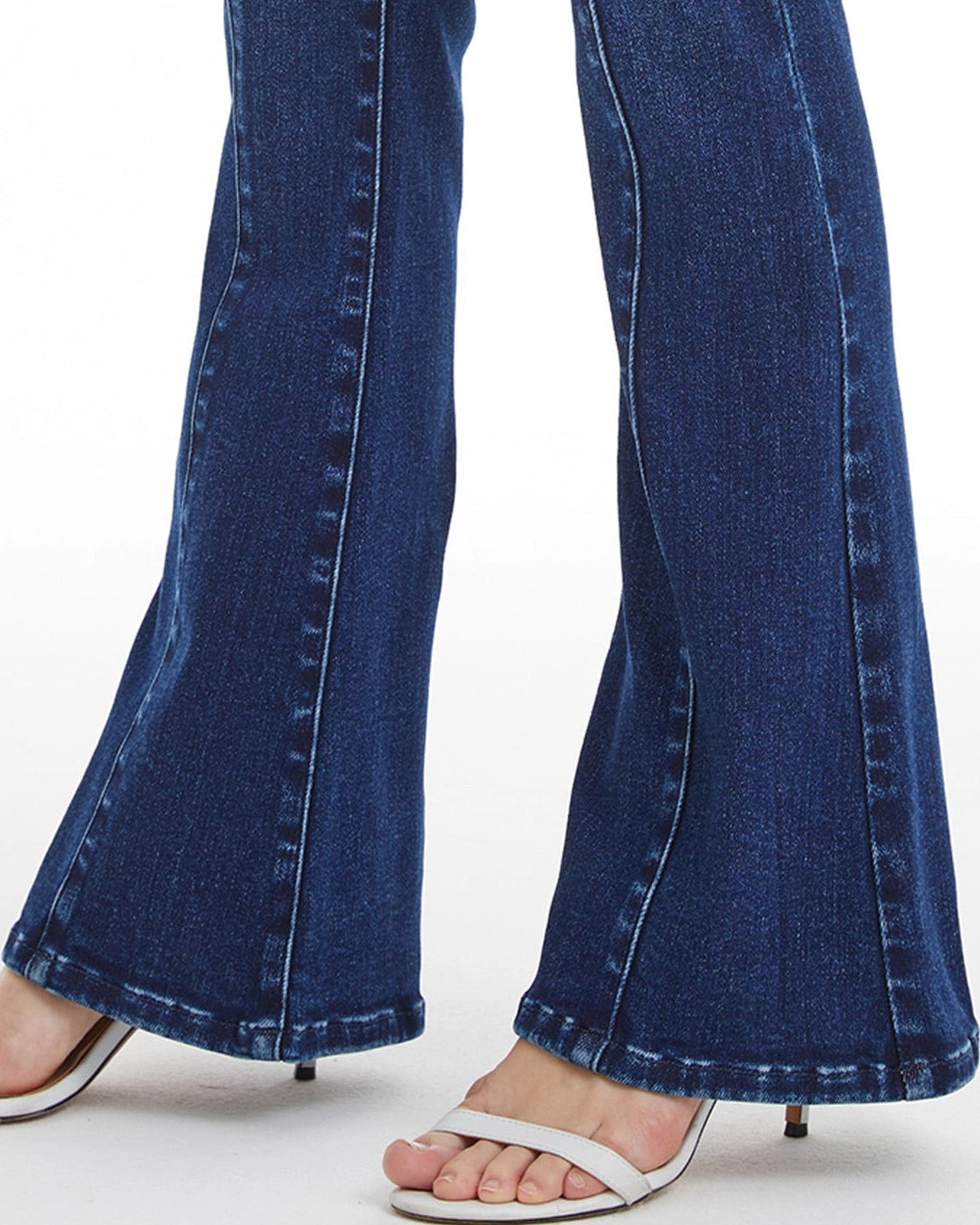 Dark blue flare jeans with V-shaped contoured waistband and button fly closure.