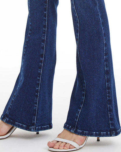 Dark blue flare jeans with V-shaped contoured waistband and button fly closure.
