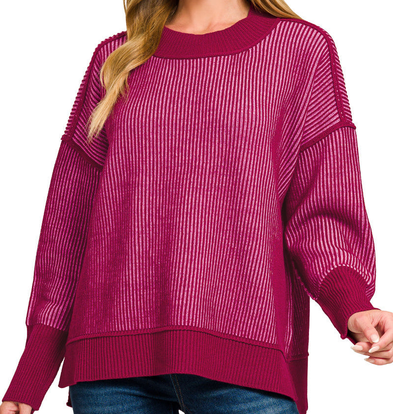 Woman wearing a cranberry/cabernet striped sweater. 