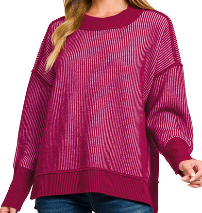 Woman wearing a cranberry/cabernet striped sweater. 