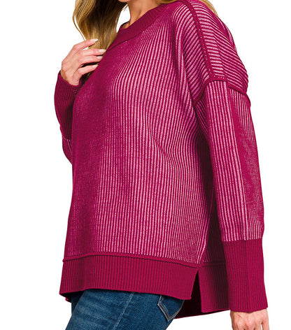 Woman wearing a cabernet candy pink sweater on a white background. 