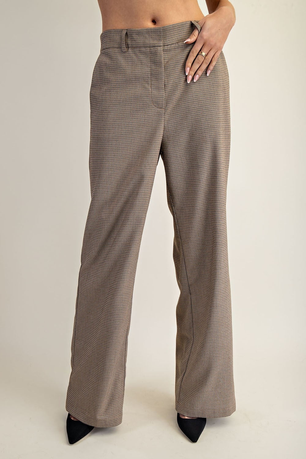 Brown checkered pants worn by a person on a plain background.
