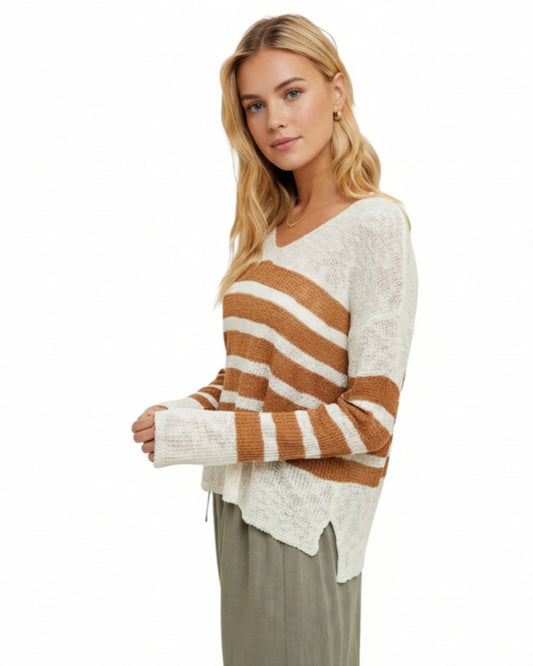 Woman wearing a striped sweater with a white background.
