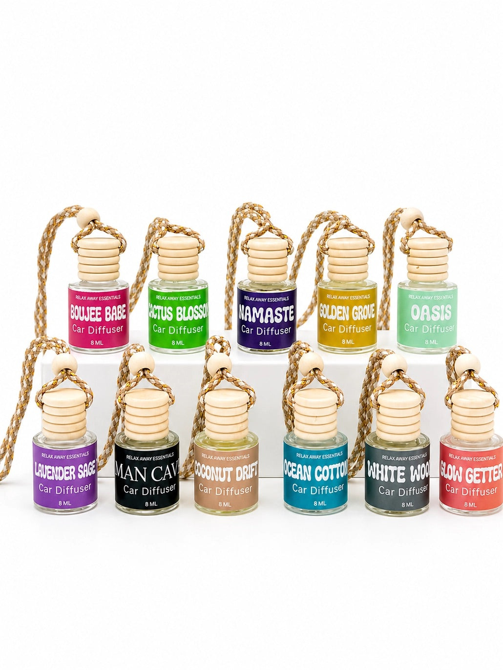 Set of small car diffuser bottles with colorful labels on a white background.