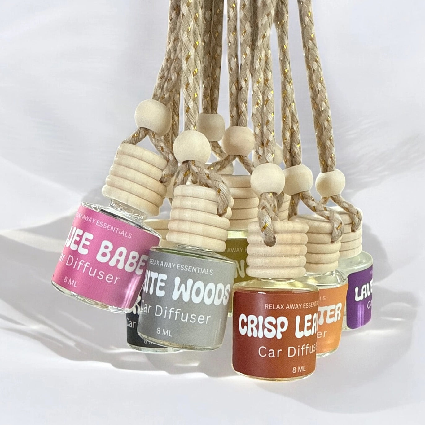Set of car diffusers with various scents on a white background.