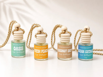 Four car diffuser bottles with different scents on a white background.