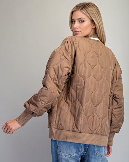 Back view of caramel mixed-media cardigan jacket with brown buttons and ivory-striped ribbed trim.