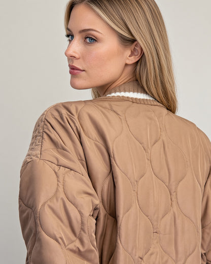 Back and side close up view of caramel cardigan jacket with quilted sleeves, textured knit shoulders, and ribbed cuffs.