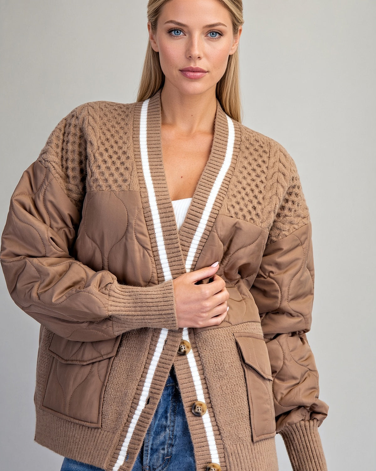 Caramel sweater jacket on model, showing quilted front panels and contrasting ivory-striped trim.