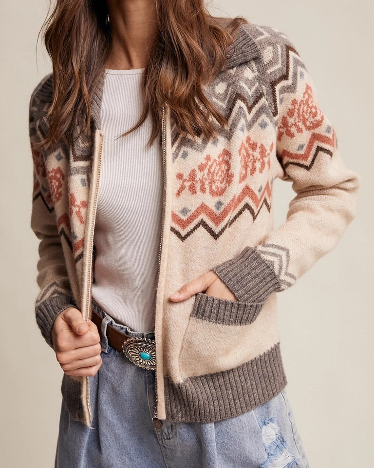Retro Rose Fair Isle Zip Cardigan in grey, oatmeal, and salmon with floral jacquard  and zigzag pattern with ribbed collar and front pockets.