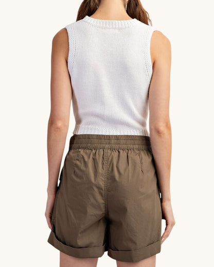 Olive cargo shorts worn by a person on a white background.
